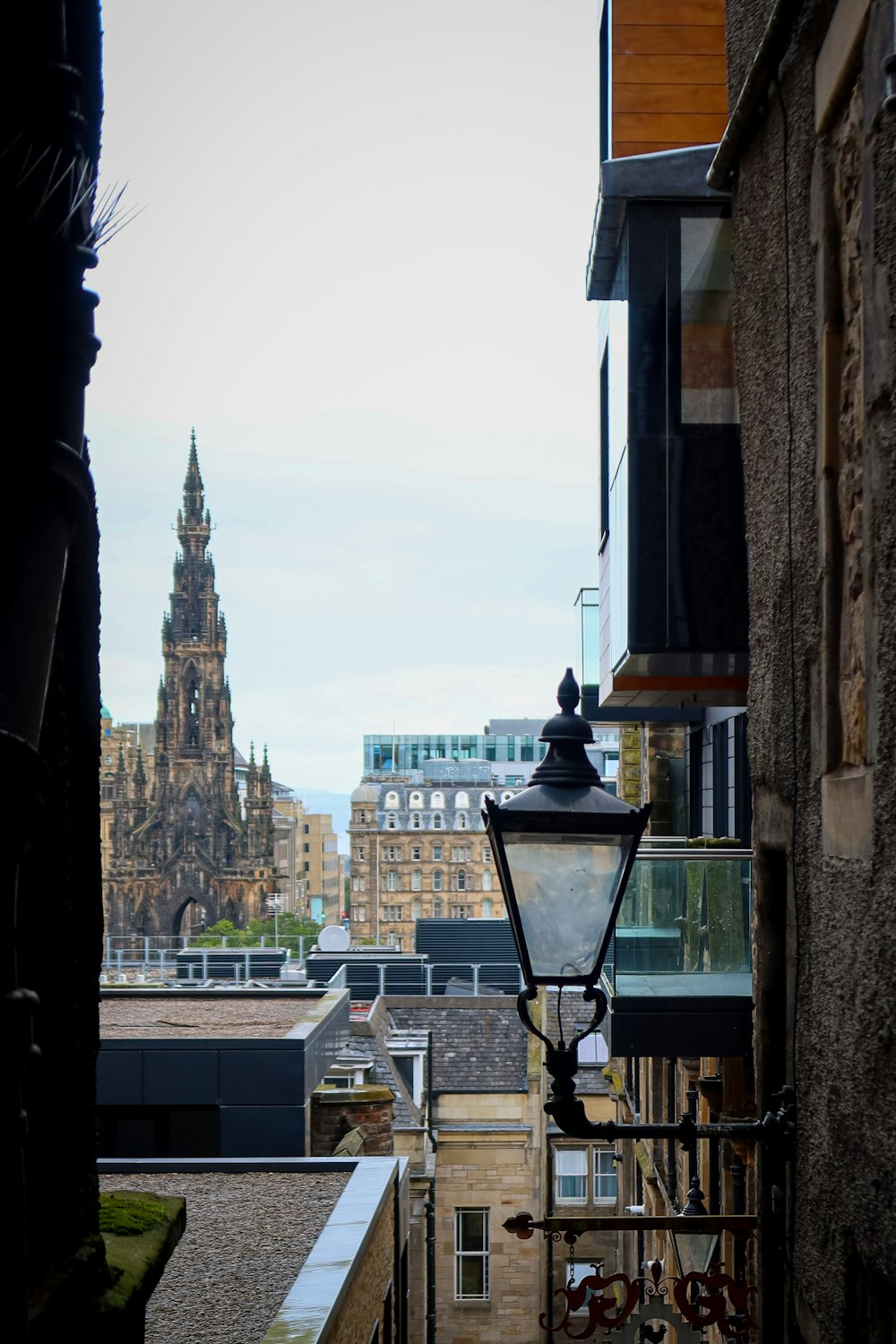 black street lamp near city buildings during daytime