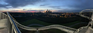 A panoramic view of a large steel bridge under construction at sunset in Latakia.