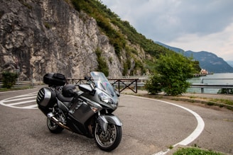 black and silver sports bike parked on gray concrete road during daytime