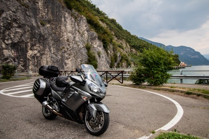 black and silver sports bike parked on gray concrete road during daytime