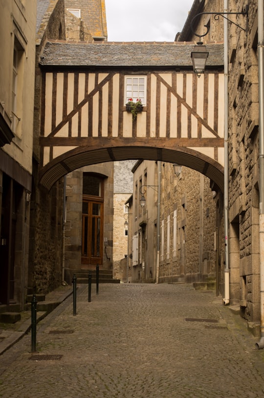 brown concrete building with arch shaped window in La Belle Epoque France