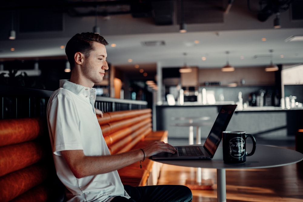 man in white button up shirt holding black tablet computer