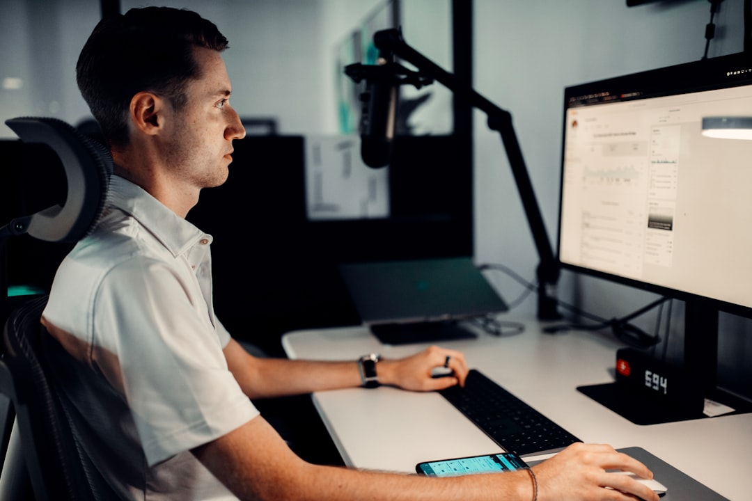 man in white button up shirt holding black computer keyboard