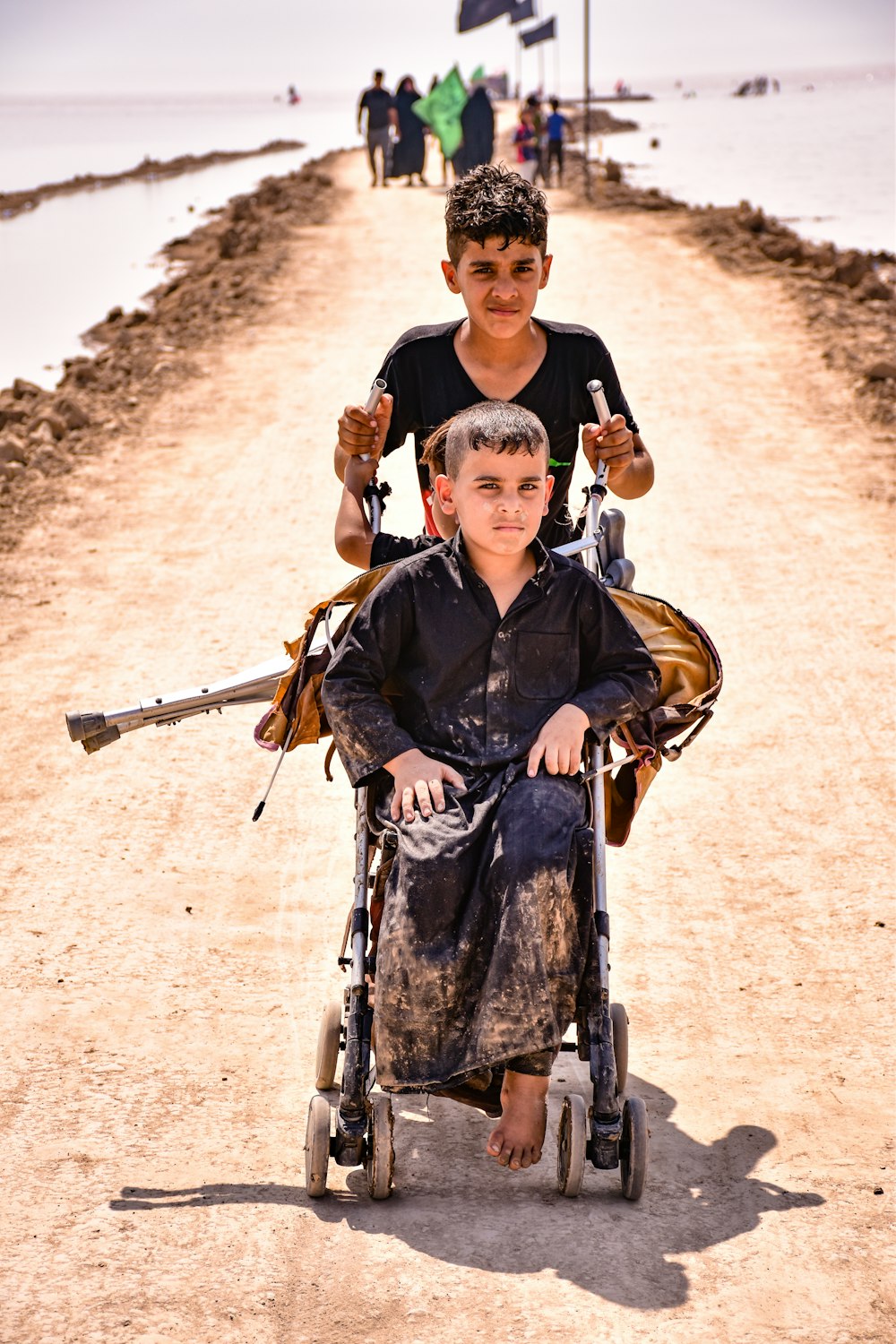 man in black jacket carrying a boy in blue jacket