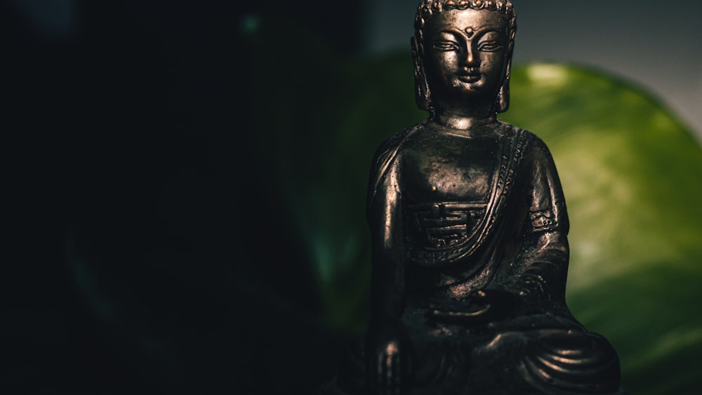 black buddha statue in black background