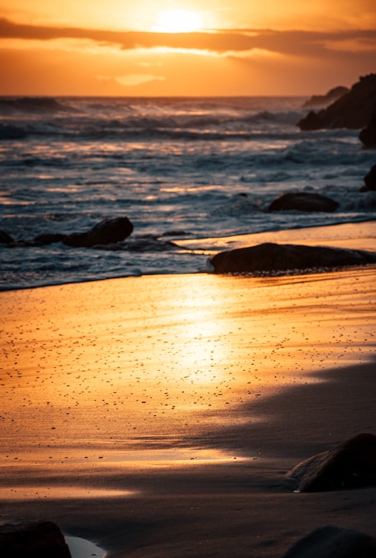 sea waves crashing on shore during sunset in Western Cape South Africa