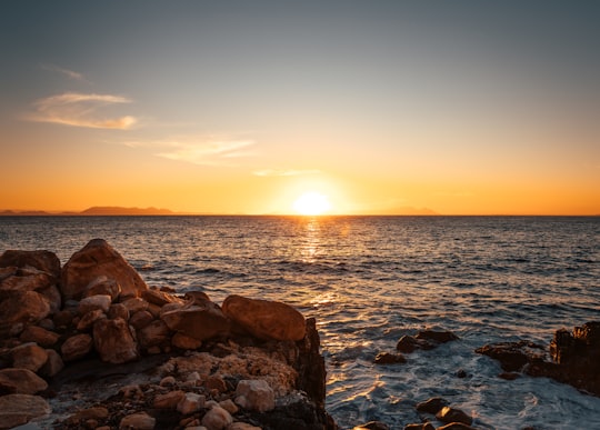 brown rocks on sea during sunset in Western Cape South Africa