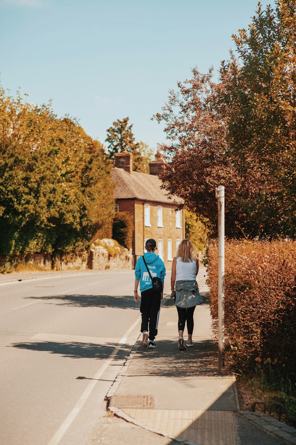 couple walking on the street during daytime