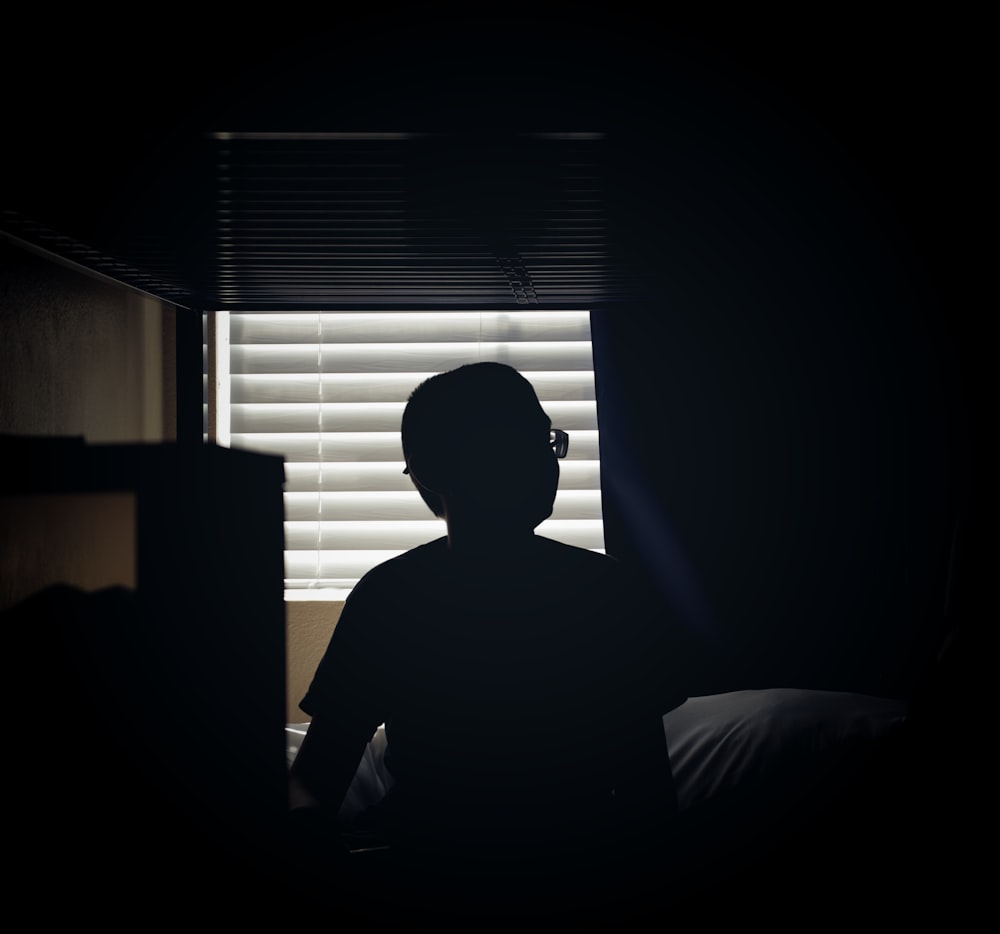 silhouette of man sitting on chair