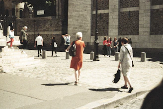 A welcoming community center entrance with people chatting outside on a sunny day.