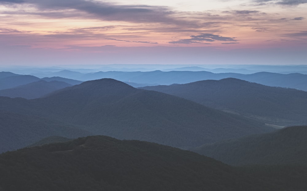 mountains under white clouds during daytime