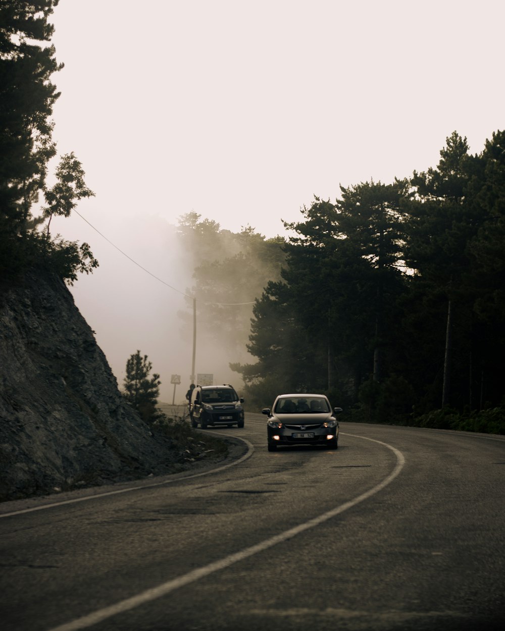 black suv on road near trees during daytime