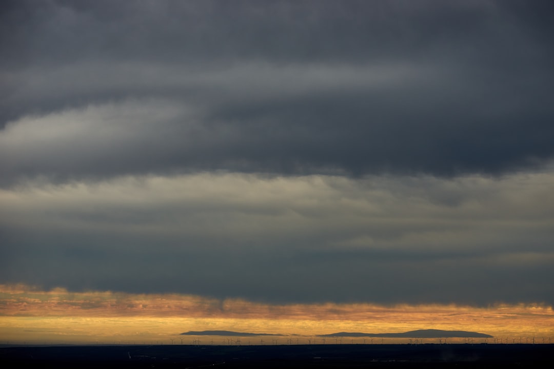 white clouds over the sea during sunset