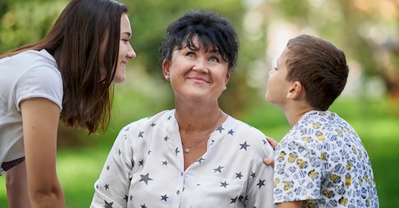 woman in white and black floral button up shirt smiling