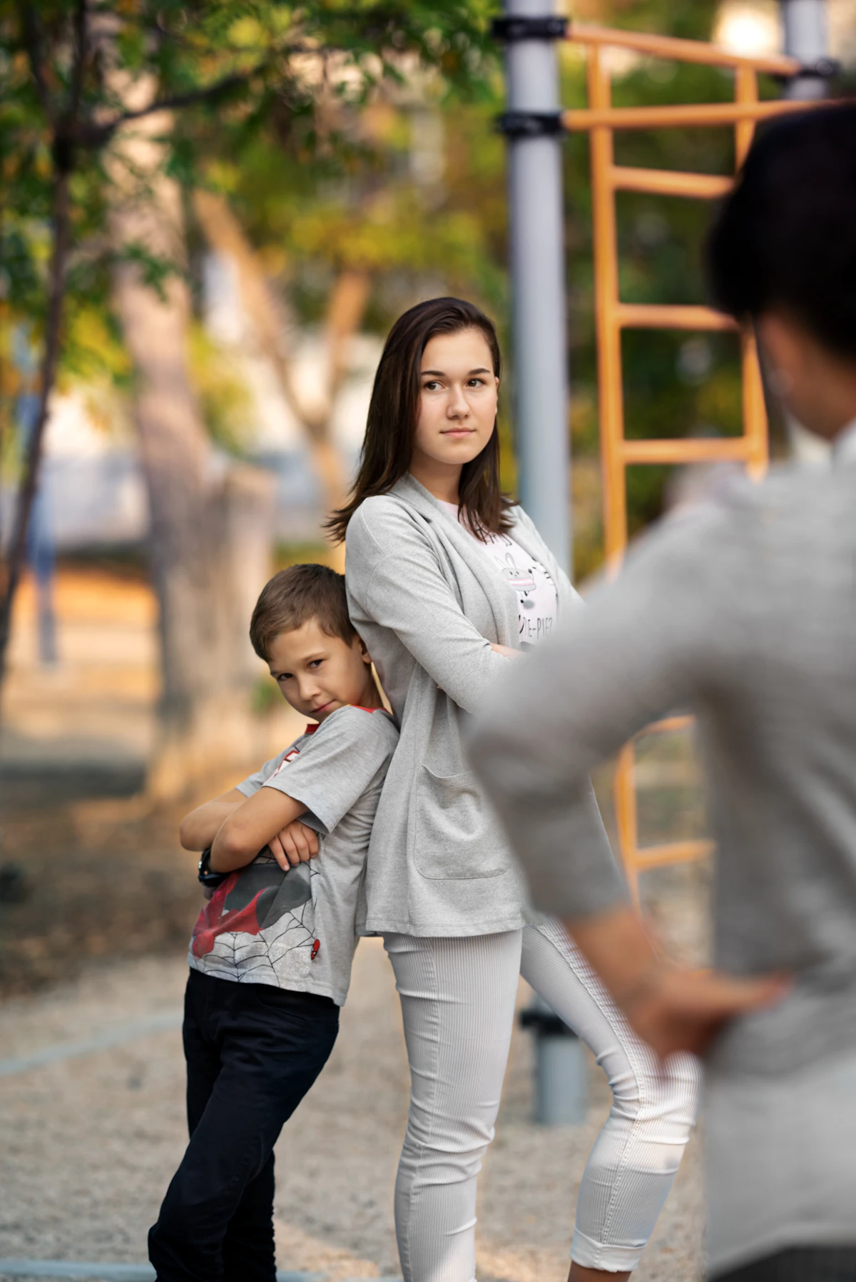 Woman in white long sleeve shirt carrying child in white long sleeve shirt