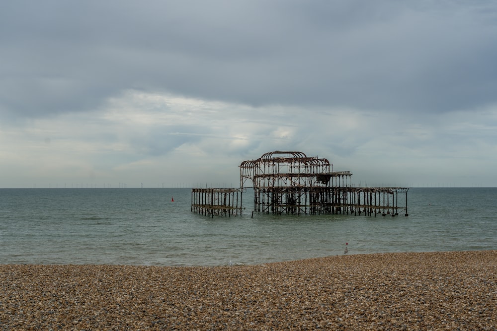 brown wooden dock on sea under white clouds during daytime