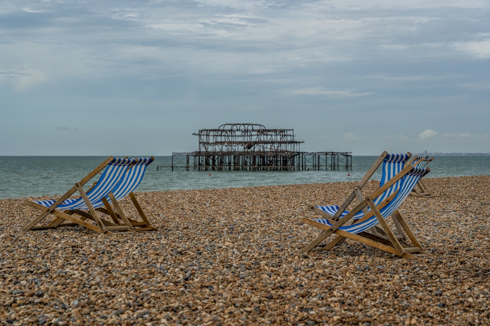 brown wooden folding chairs on beach during daytime