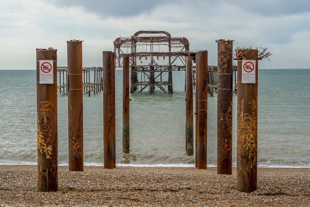 brown wooden posts on beach during daytime