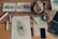 Close-up of architectural blueprints and construction tools on a wooden table.