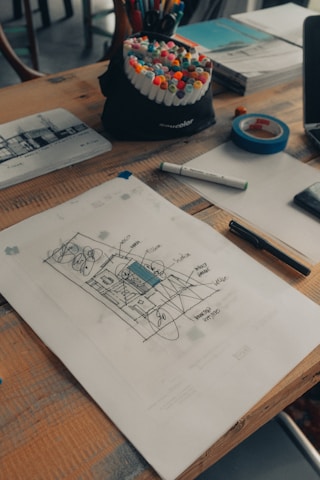 white printer paper beside pen and pen