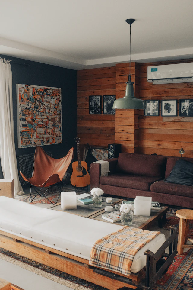 Living room with a brown sofa, a coffee table, and framed pictures