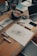 A creative workspace filled with art supplies and colorful sketches on a wooden table.