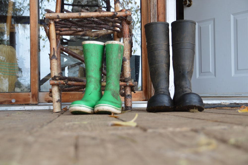 green rain boots on brown wooden ladder