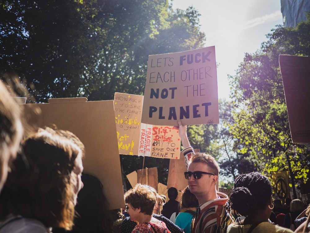 people holding a happy birthday signage