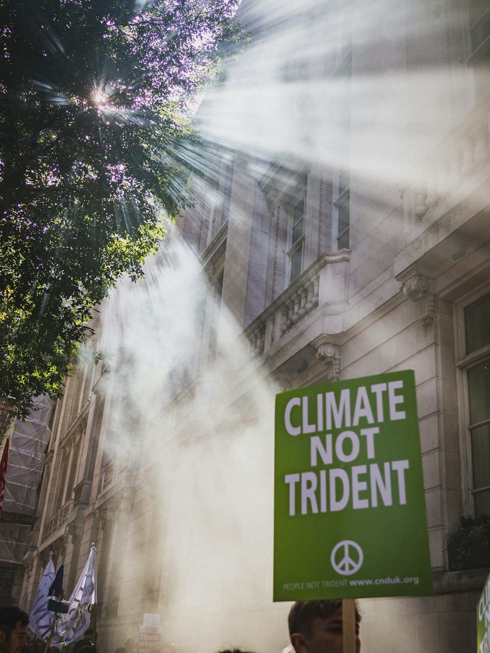 a climate not trident sign in front of a building