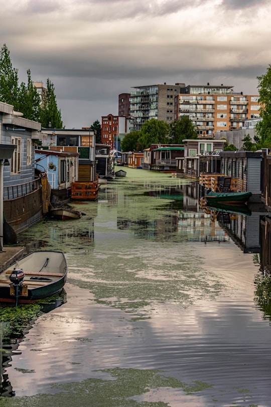 boat on water near buildings during daytime in Groningen Netherlands