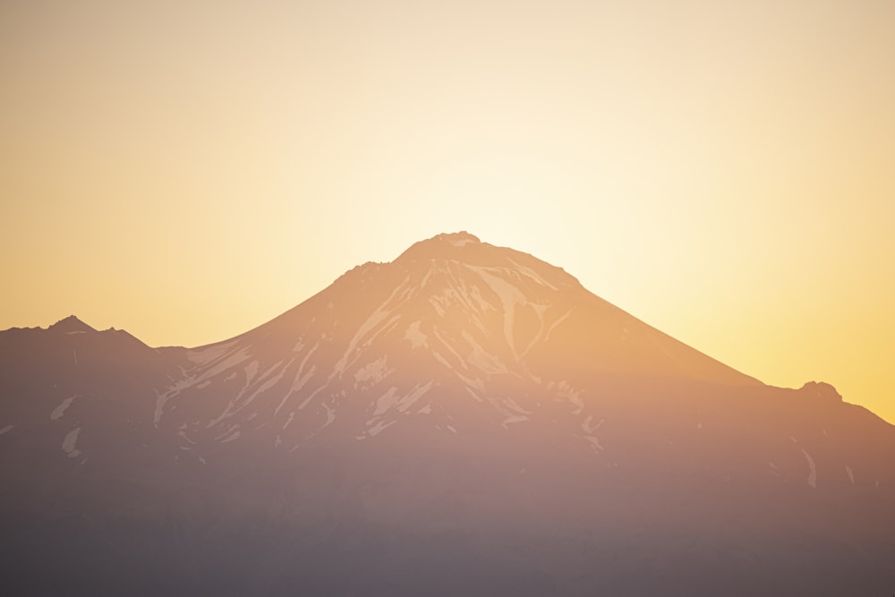 snow covered mountain under cloudy sky during daytime