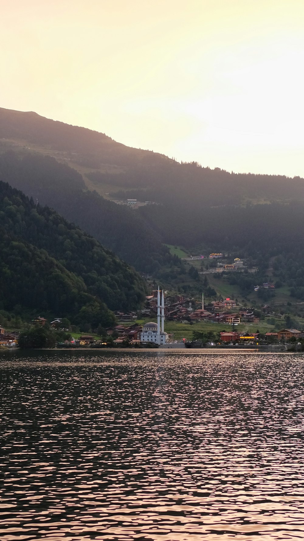 green mountains near body of water during daytime