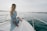 woman in white long sleeve shirt sitting on white boat during daytime