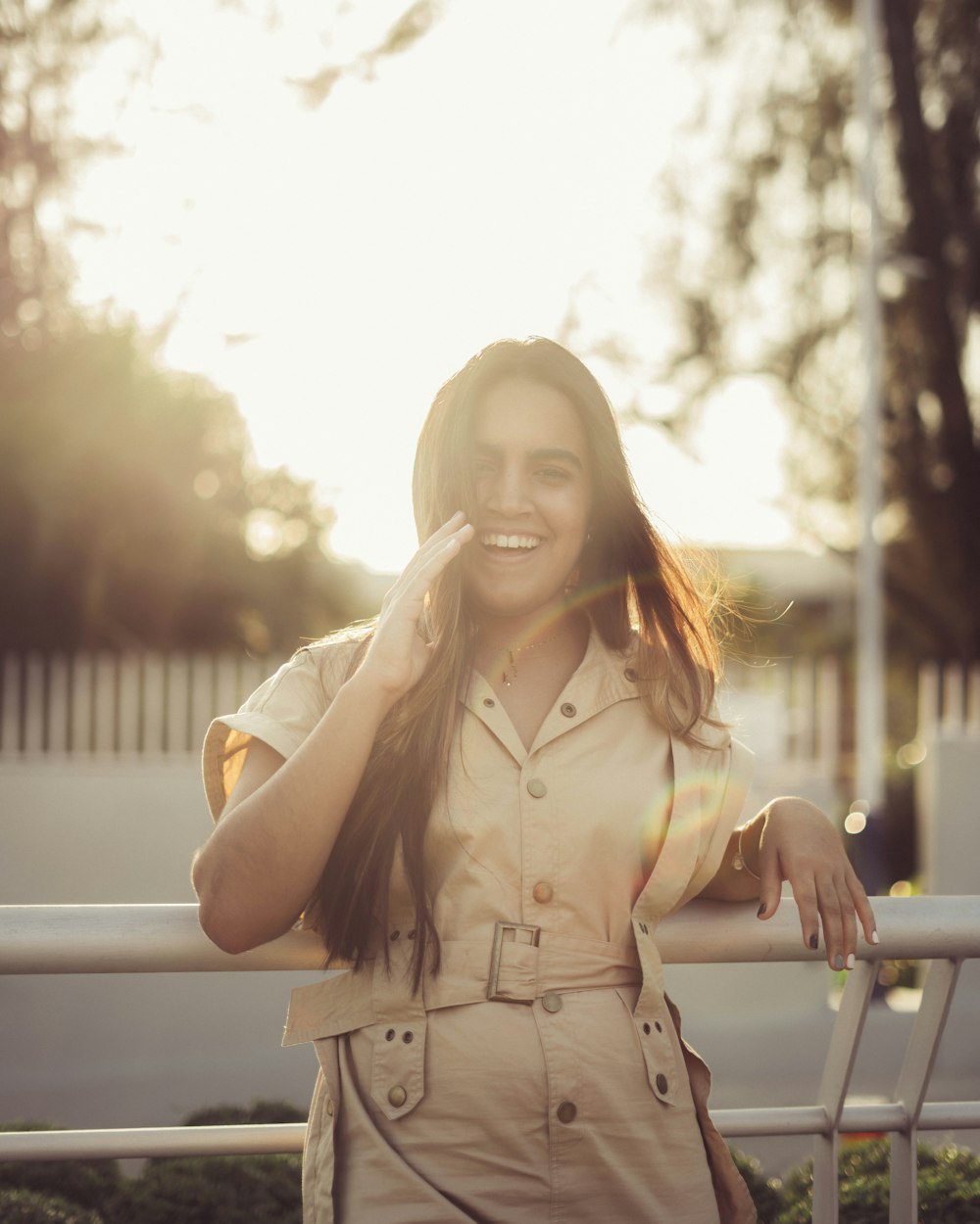 woman in brown coat standing and smiling