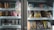 A refrigerated display case containing a variety of packaged goods. The left side features colorful beverage cups and a promotional sign for a watermelon lychee frappe. The right side has shelves with packaged snacks such as cheese and mochi items. Pricing labels are visible above each shelf.