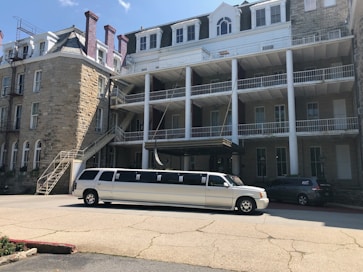 A limousine arriving at a luxury resort, ready to welcome guests for a corporate themed event.