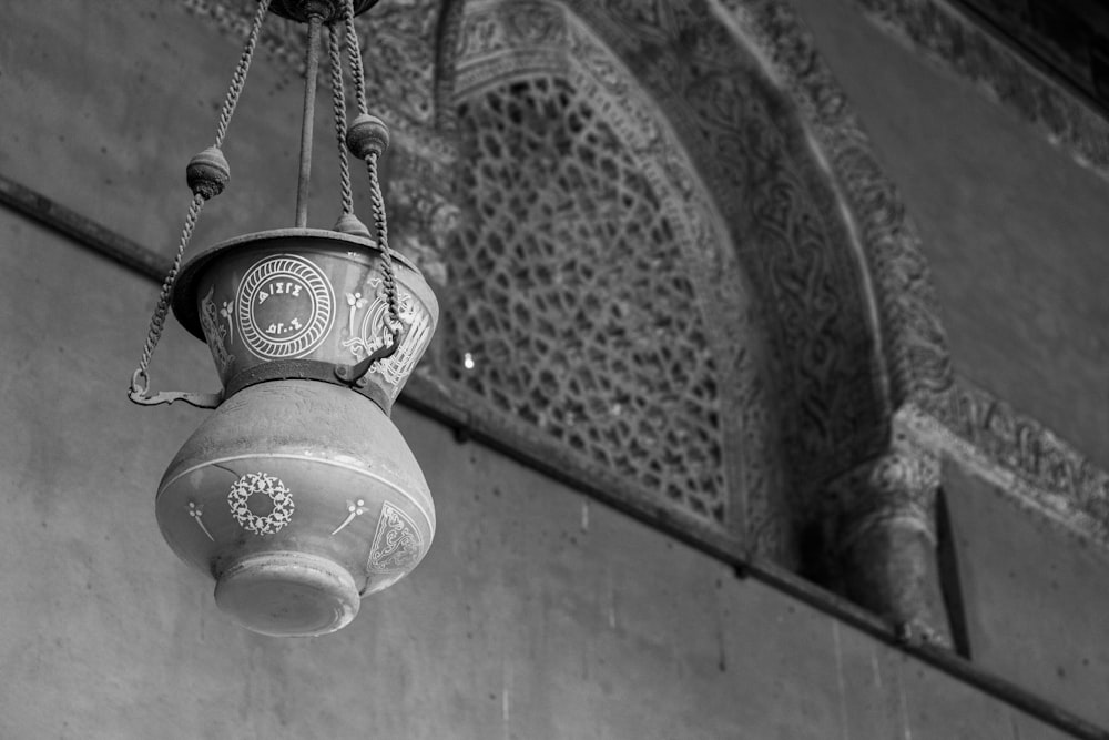 grayscale photo of round pendant lamp