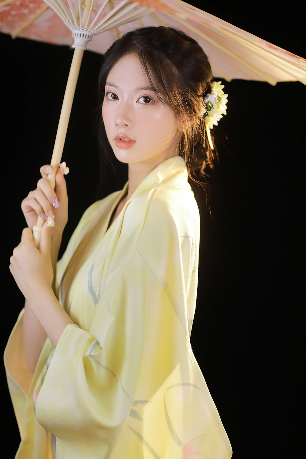 woman in yellow robe holding brown wooden stick