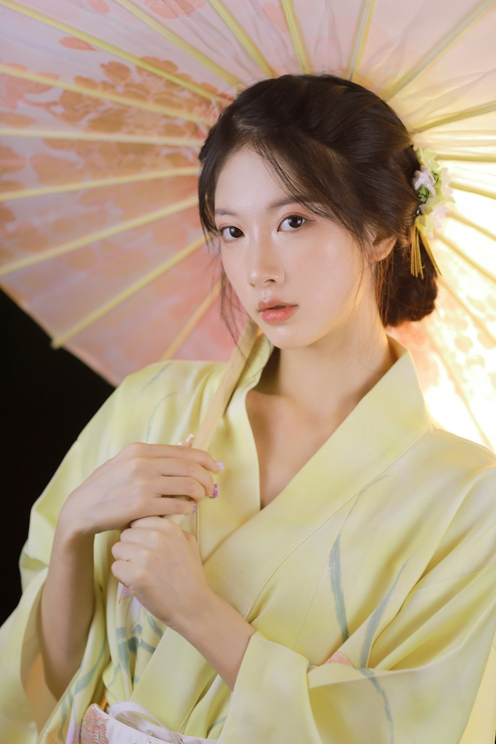 woman in white blazer holding pink umbrella