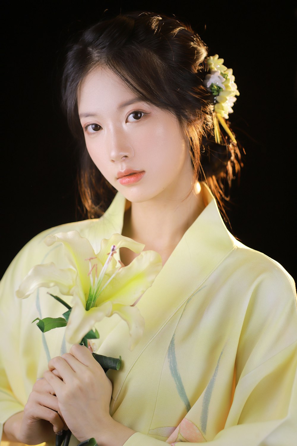 woman in white dress shirt with white flower on ear