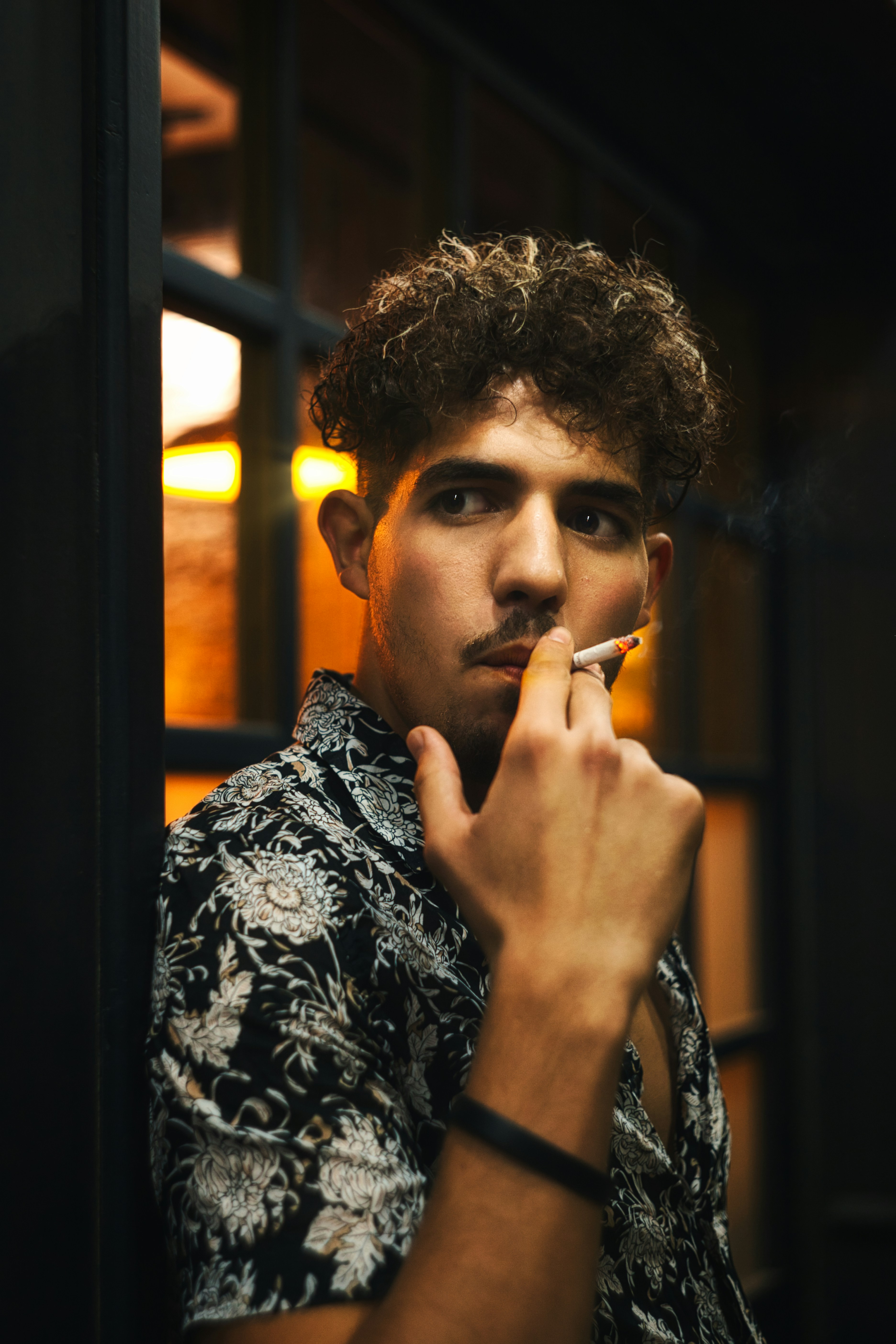 man smoking cigarette in room