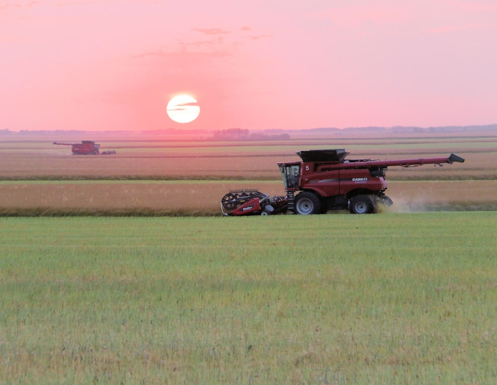 red and black truck on green grass field during daytime