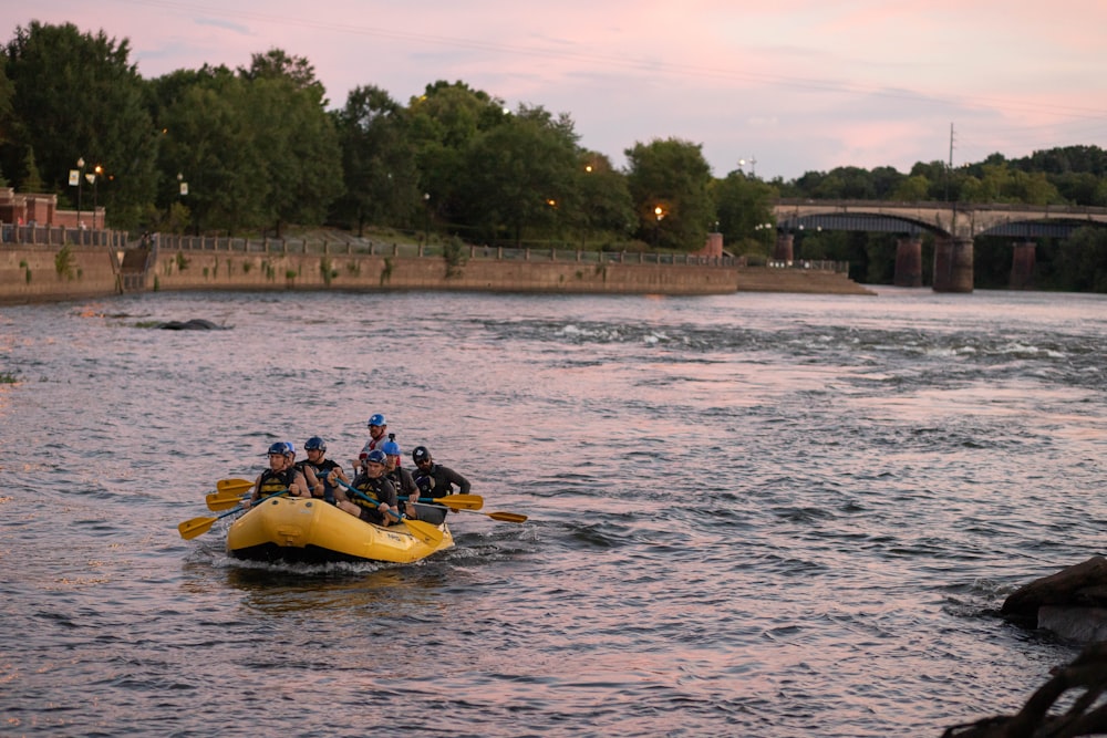 2 people riding yellow kayak on body of water during daytime