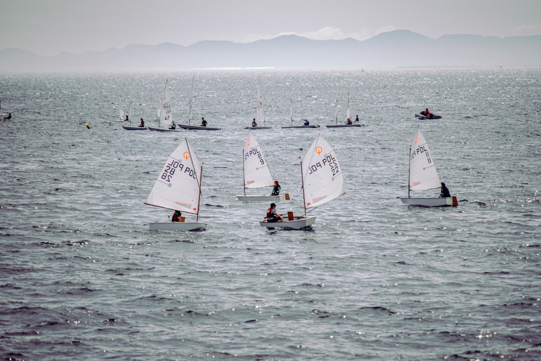 people riding on sail boat on sea during daytime