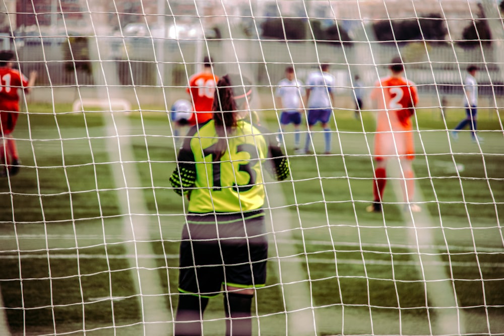 woman in yellow and black jersey shirt standing on field