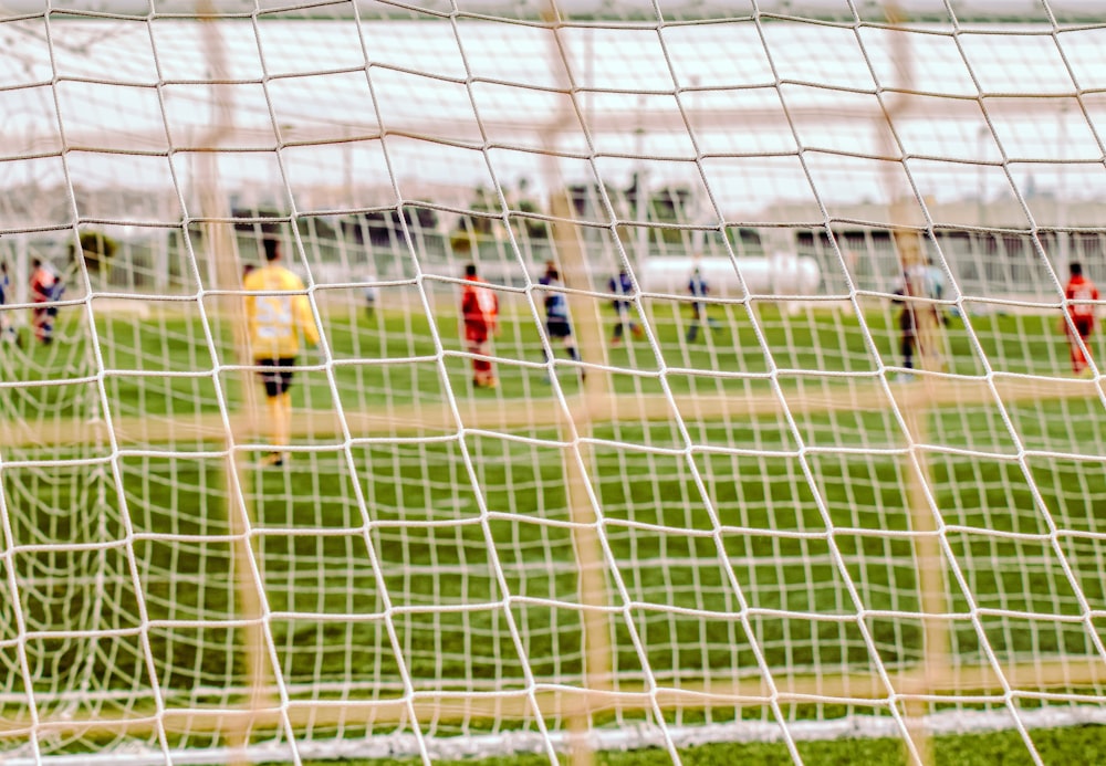 people playing soccer during daytime