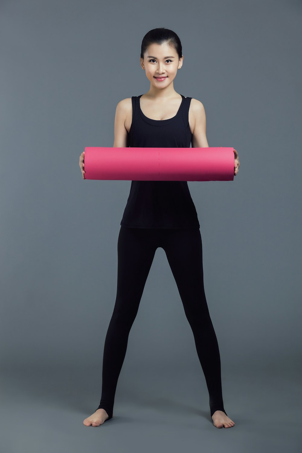 woman in red tank top and black pants