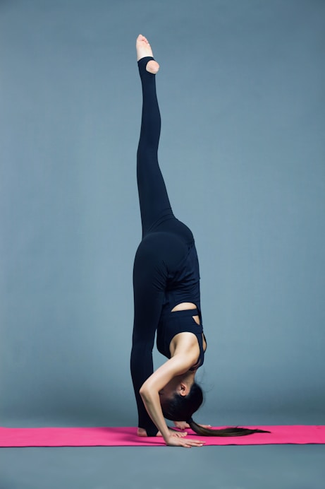 woman in black tank top and black leggings doing yoga