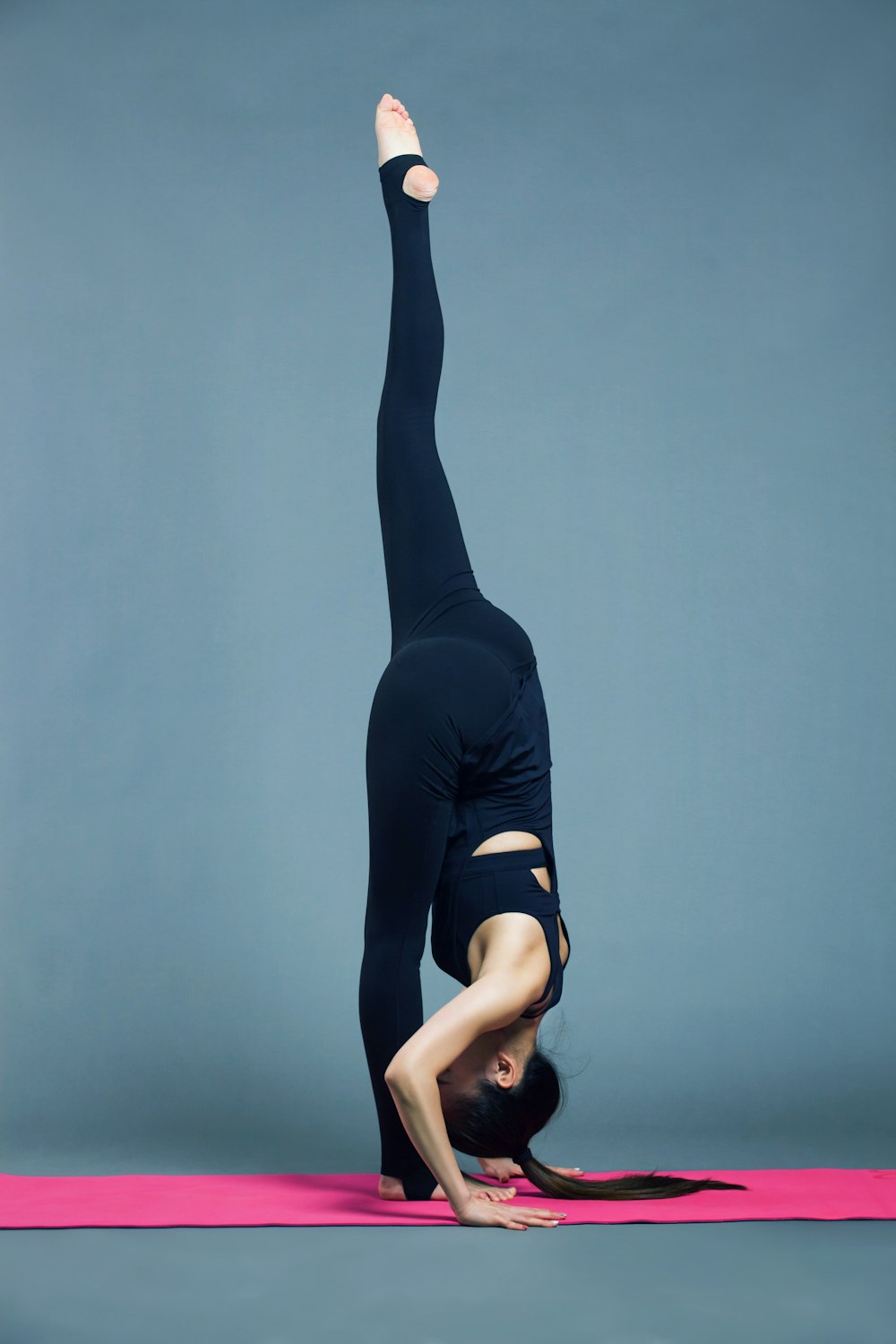 woman in black tank top and black leggings doing yoga