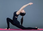 woman in black tank top and black pants doing yoga